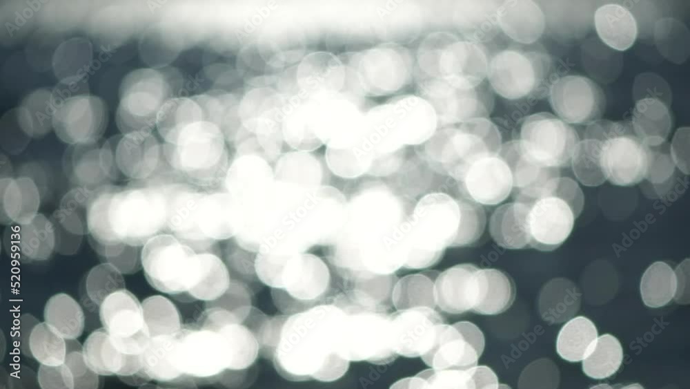 Abstract nature summer ocean sunset sea background. Small waves on water surface in motion blur with bokeh lights from sunrise. Holiday, vacation and recreational background concept. Slow motion Abstract nature summer ocean sunset sea background. Small waves on water surface in motion blur with bokeh lights from sunrise. Holiday, vacation and recreational background concept. Slow motion