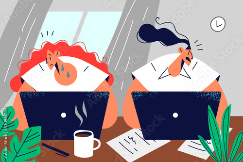 Unfriendly employee working in office with upset colleague 