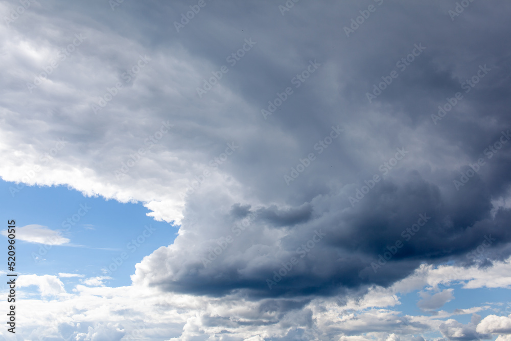 Big white clouds in a blue sky close-up. There is a place for the text ...