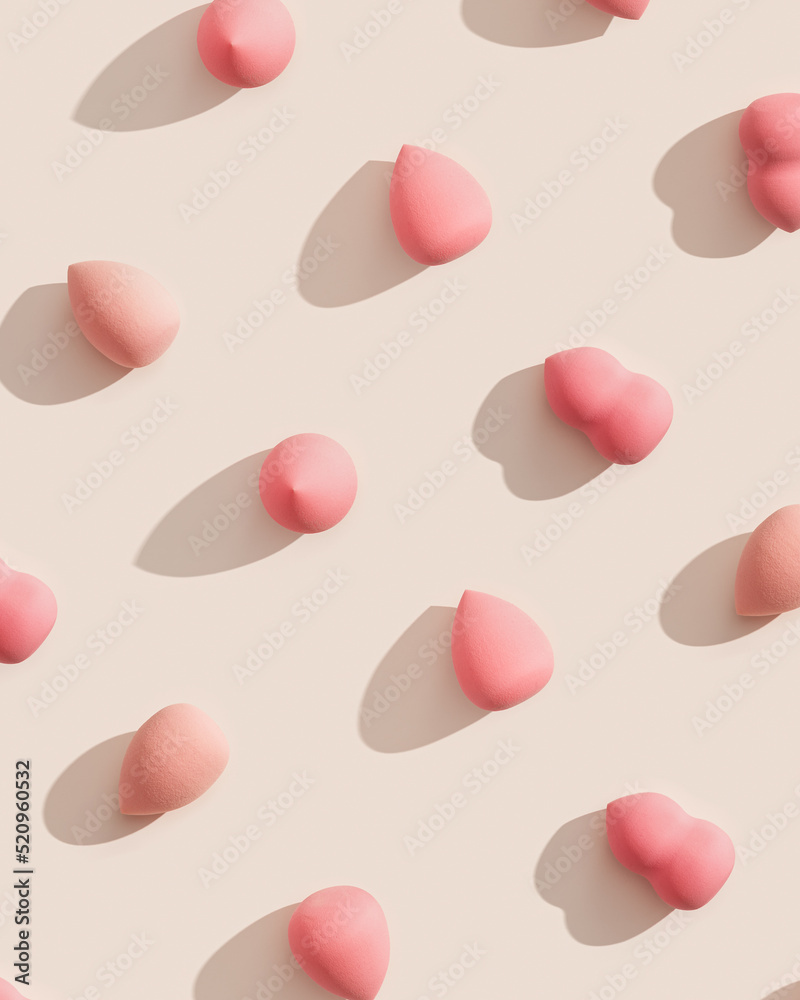 Geometric pattern from makeup sponges for foundation cream on beige background with dark shadows. Beauty blender pink and beige. Fashion Flat lay cosmetic sponge, top view graphic layout