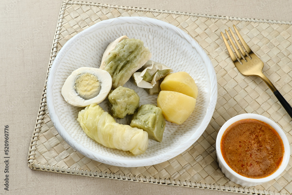 Siomay Bandung (Shumay) or steamed dumplings with boiled egg, tofu, potatoes and cabbage roll. Indonesian traditional street food with peanut sauce and soy sauce, served with green lime.
Siomay Bandung (Shumay) or steamed dumplings with boiled egg, tofu, potatoes and cabbage roll. Indonesian traditional street food with peanut sauce and soy sauce, served with green lime.