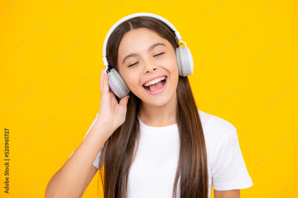 Child music concept. Teenager child girl dances in rhythm of melody, listens song in headphones. Child listening to music through earphones. Child music concept. Teenager child girl dances in rhythm of melody, listens song in headphones. Child listening to music through earphones.