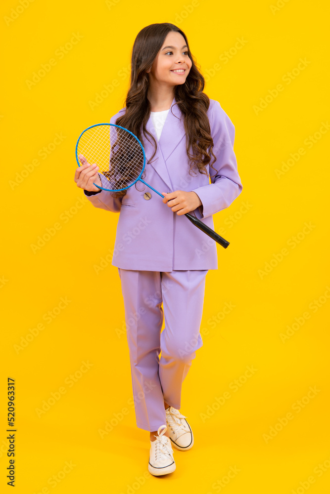 Teen girl badminton player in suit with badminton racket isolated on yellow background. Teen girl badminton player in suit with badminton racket isolated on yellow background.
