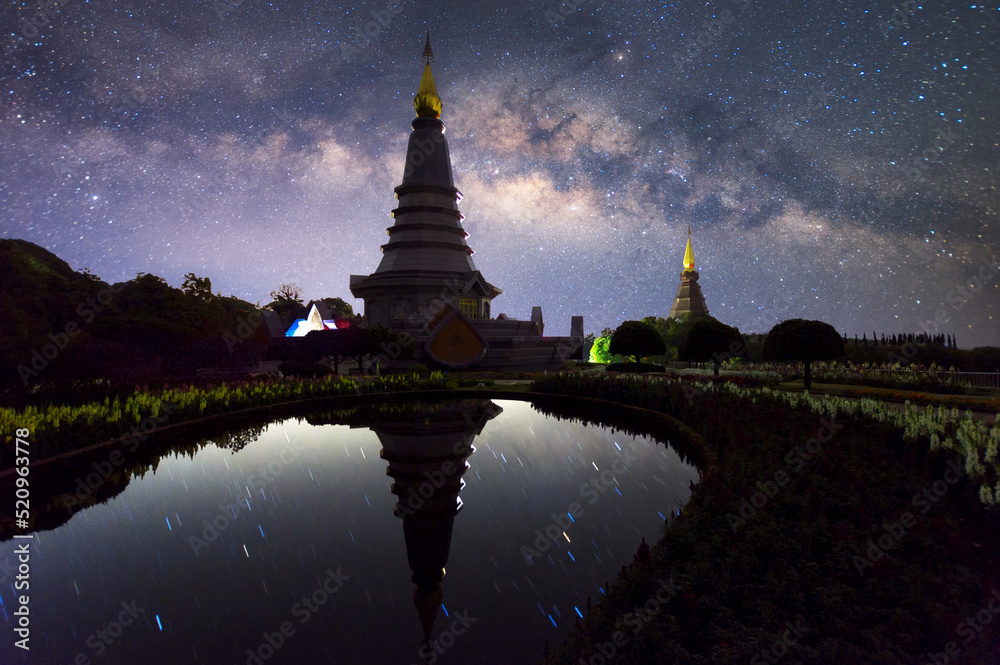 The Milky Way Galaxy moving over a sacred temple at Doi Inthanon National Park, Chiang Mai, Thailand. Night lapse from night to day. Starry night.