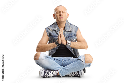 Bald man sitting with crossed legs and practicing meditation