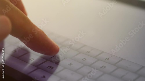 close up of a hand holding a tablet computer