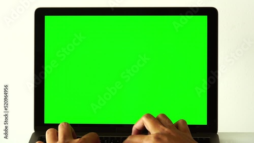 hands holding computer labtop with green screen