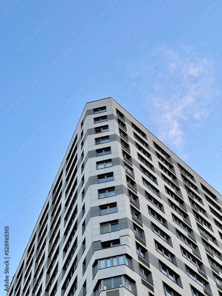 Modern office building on blue sky background