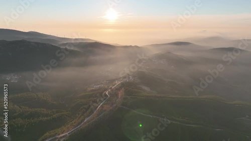 Sunset in the countryside of Portugal. Forest covered hills and light fog at dusk. Coimbra district - Cantoneiros and Cerdeira. photo