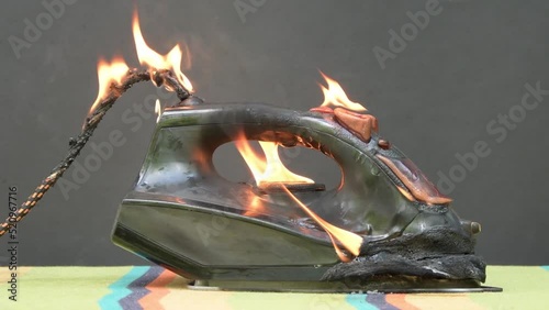 A fire from an electric iron on an ironing board 3 photo