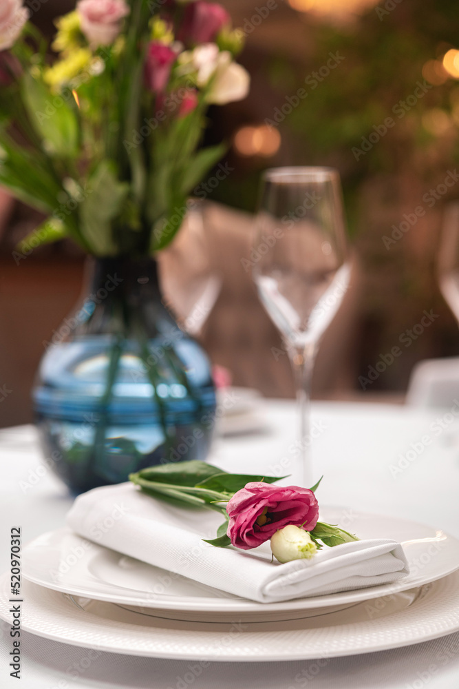 Beautiful table setting with rose flowers.