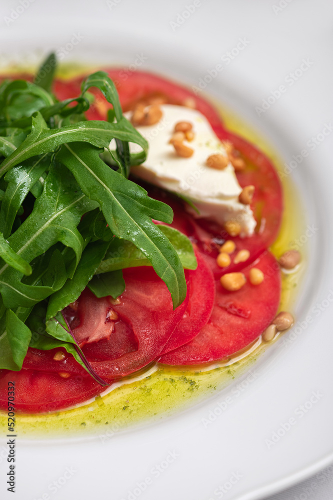 Fresh caprese salad on a white plate. Fresh caprese salad on a white plate.