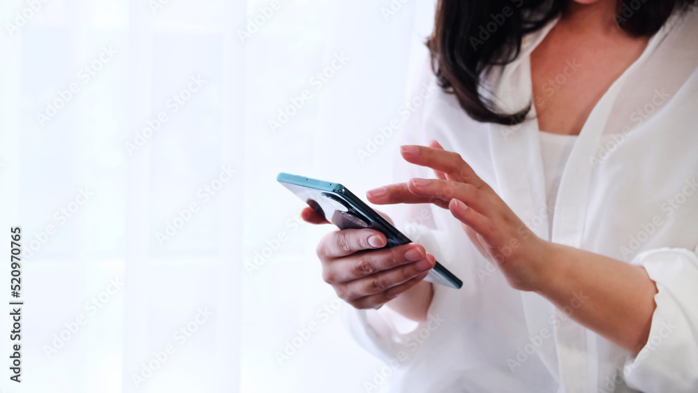 Woman using mobile phone. lady use of cellphone at home. Unrecognizable woman playing game on the phone. play video games on smartphone. Woman using mobile phone. lady use of cellphone at home. Unrecognizable woman playing game on the phone. play video games on smartphone.