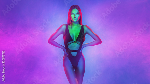 Fashionable glamour beautiful woman with Trendy wavy neon light hairstyle. Party night club vibes, gel filter. Excited shapely sexy girl. Art fashion creative neon color.