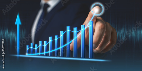 Businessman draws growth graph of business. Business development and planning success concept