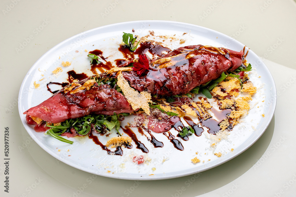 Raw beef tartare with parmesan cheese and wine sauce.
