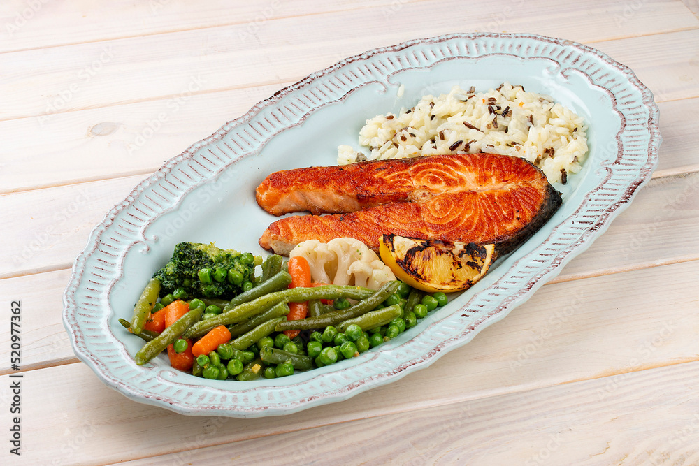 Grilled salmon steak with brown rice and vegetables. Grilled salmon steak with brown rice and vegetables.