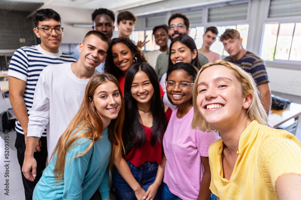 United multiracial big group of student friends taking selfie with teacher at college - Teenage high school people having fun together in classroom - Youth lifestyle, education and community concept