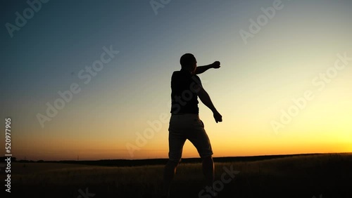 Happy man jumping on sunset sky background. Freedom feel good and travel adventure concept.