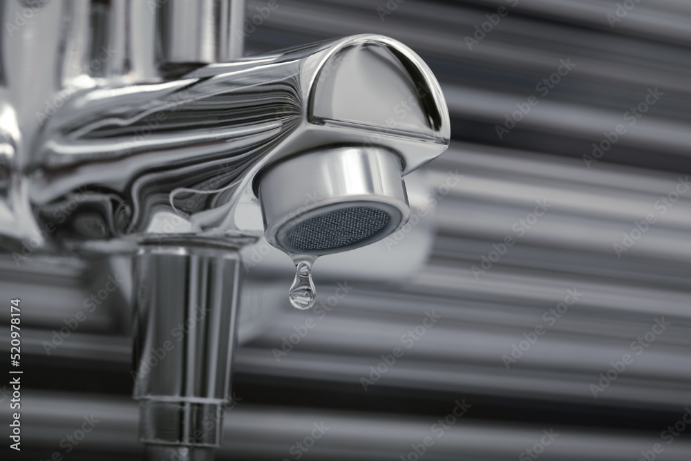 Water drops falling down from tap on blurred background, closeup. Space for text Water drops falling down from tap on blurred background, closeup. Space for text
