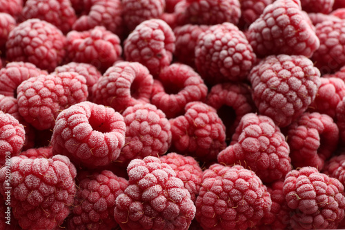 Tasty frozen raspberries as background  closeup view