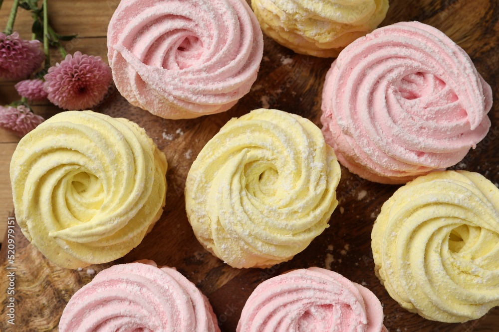 Delicious pink and yellow marshmallows on wooden table, flat lay Delicious pink and yellow marshmallows on wooden table, flat lay