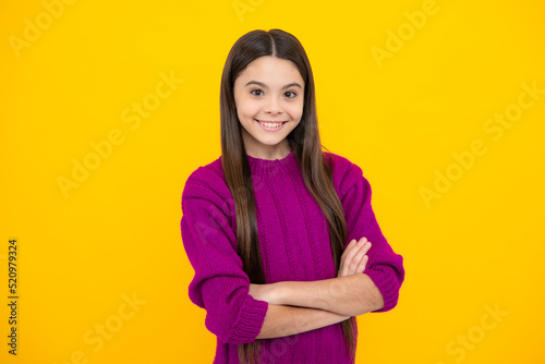 Portrait of teenager girl crossed arms isolated on yellow color background. Children lifestyle childhood concept.