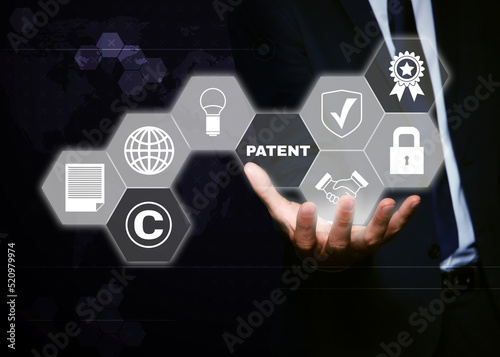 Patent concept. Different virtual icons and man on dark background, closeup