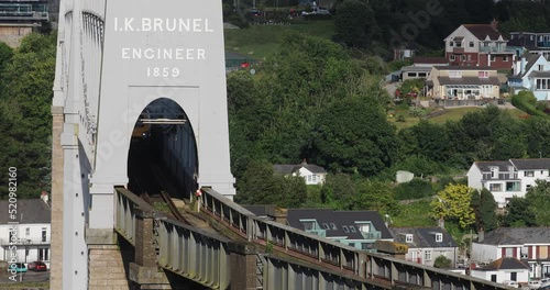 The Royal Albert Bridge Over the River Tamar built by Isambard Kingdom Brunel with a Cross Country Train Crossing Over the Bridge on a Summer's Day in England. photo