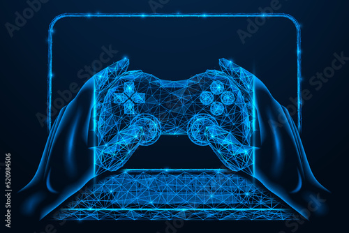 Gaming gamepad in the hands on the background of a laptop. Playing a network game. Low-poly design of interconnected lines and dots.