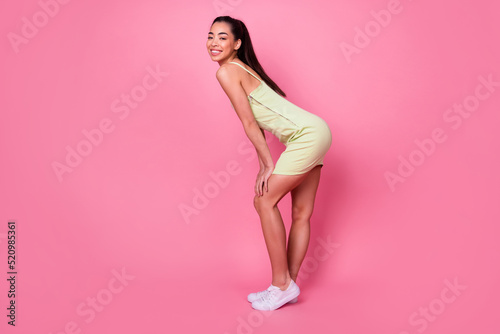 Profile side full length photo of positive lady standing smiling toothy isolated on pastel color background