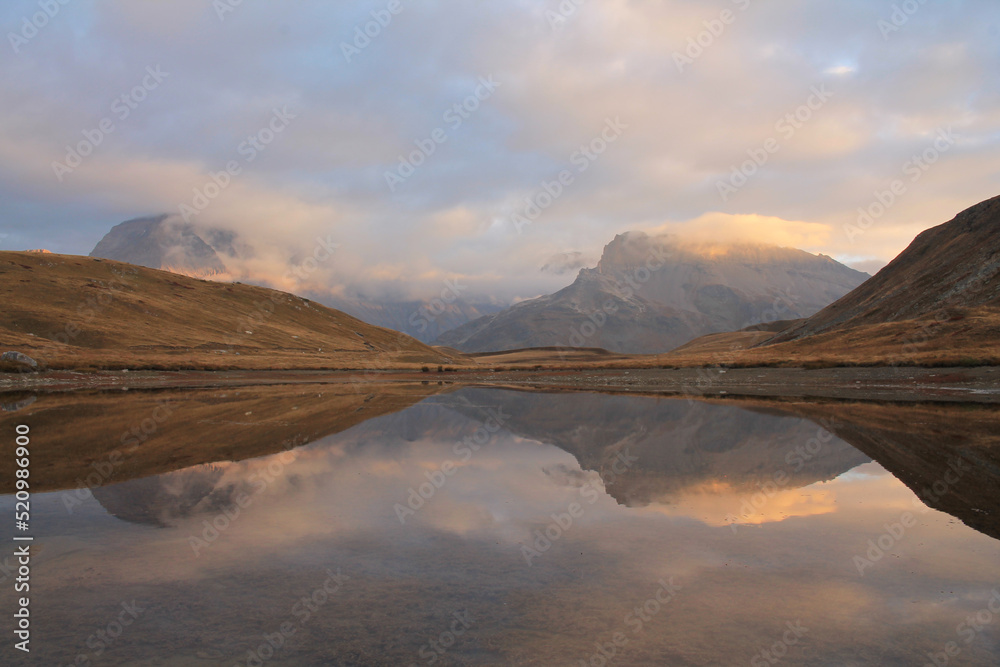 Obraz premium Amazing reflections in lake Plan du Lac Bellecombe looking towards La Grande Casse in the French alps