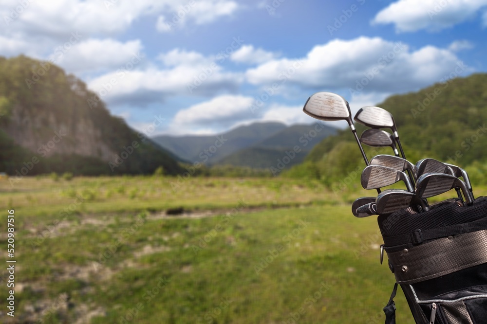 Fototapeta premium The Golf club bag for golfer training and play in game with golf course background, green nature