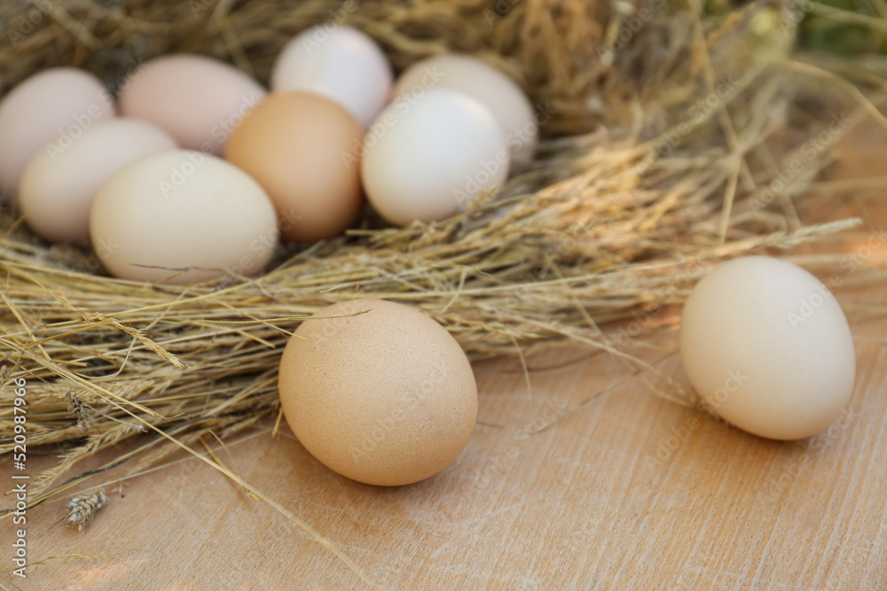 Nest with fresh raw eggs on wooden table, closeup Nest with fresh raw eggs on wooden table, closeup