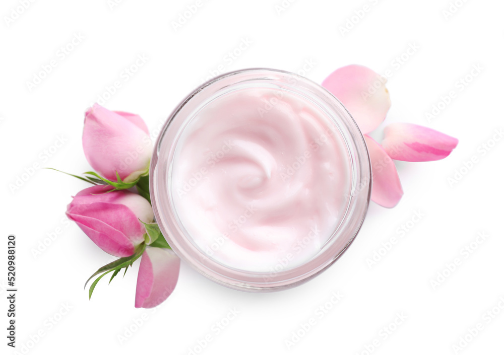 Jar of hand cream and roses on white background, top view