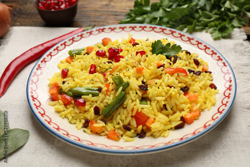 Tasty rice pilaf with vegetables on table