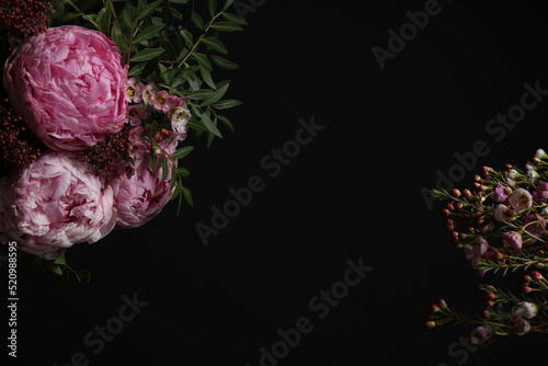 Beautiful fresh flowers on black background, space for text © New Africa