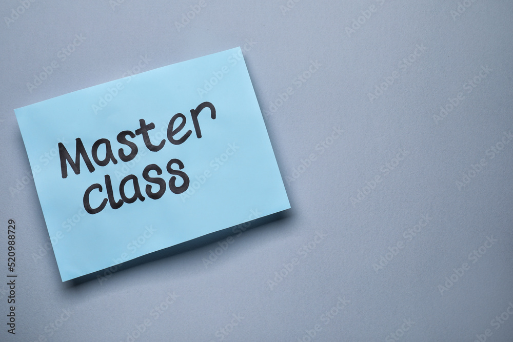 Paper note with words Master Class on grey background, top view. Space for text Paper note with words Master Class on grey background, top view. Space for text