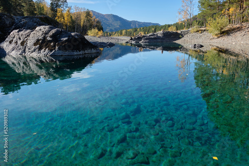 Turquoise clear water in a mountain lake. Autumn Altai.