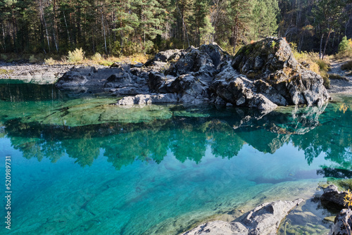 Turquoise clear water in a mountain lake. Autumn Altai.