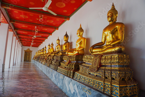 Row Of Buddha statue at "Wat Pho",that famous and popular tourist attraction in Bangkok Thailand. © Panchanit