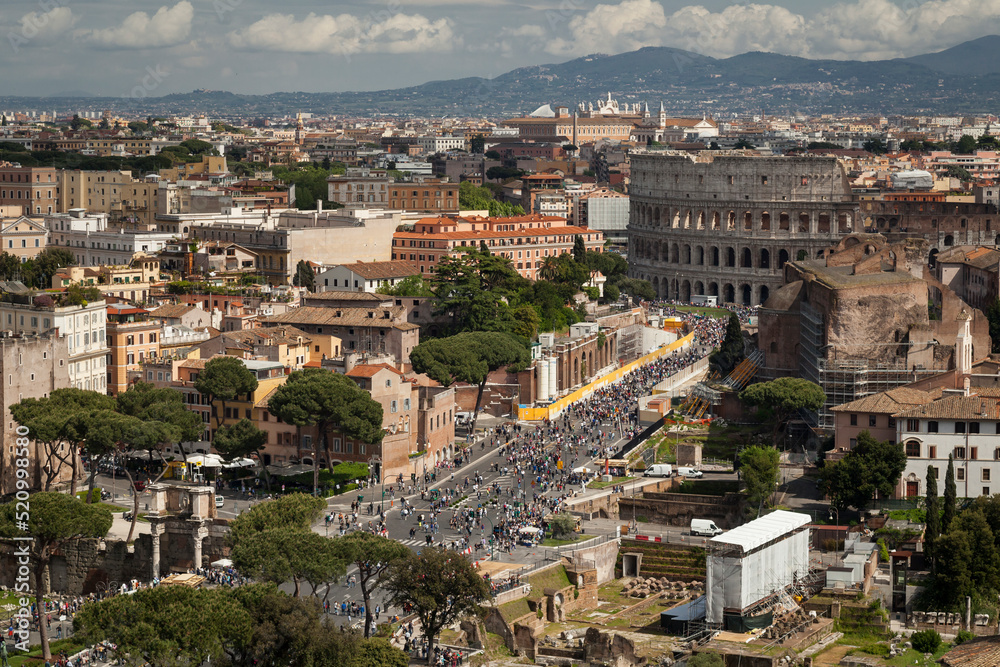 Via dei Fori Imperiali with the Colosseum in the background in Rome