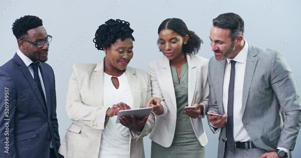 Group or team of business people working and browsing with wireless technology in studio against a grey background. Digital marketing colleagues networking online to advertise a startup company