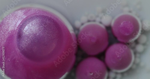 Macro structure of multicolored water paint pink oil bubbles.