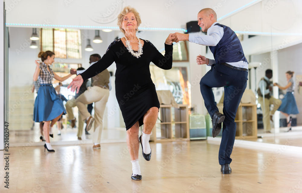 Mature woman dancing swing with young man Mature woman dancing swing with young man