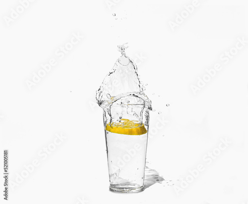 glass of clear water with a splash of lemon