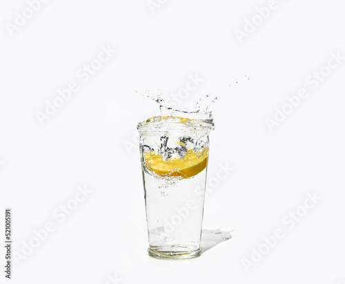 glass of clear water with a splash of lemon