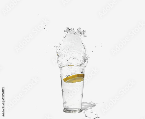 glass of clear water with a splash of lemon