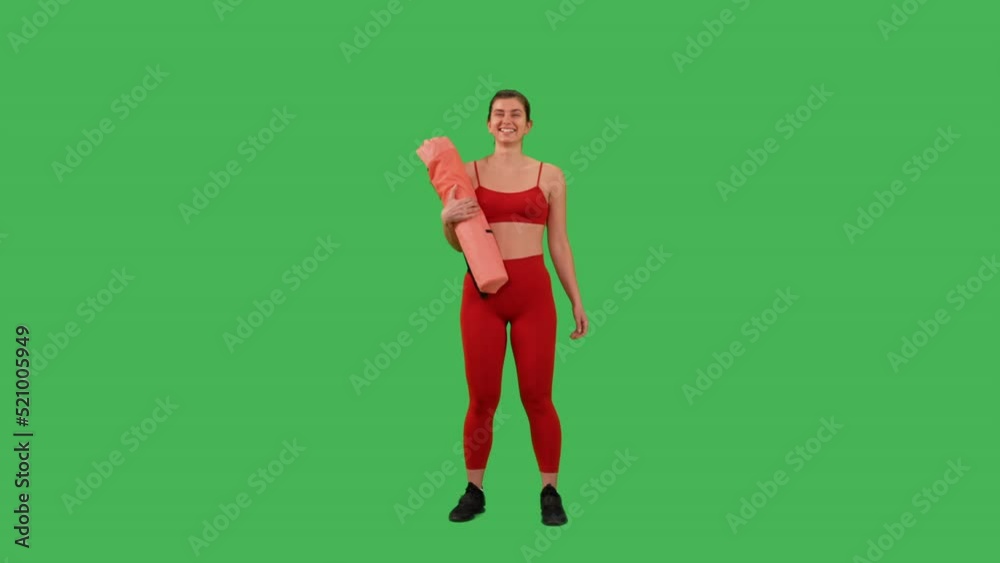 cheerful woman posing with yoga mat smiling to the camera Isolated on Green Screen background dressed red sport top and leggings cheerful woman posing with yoga mat smiling to the camera Isolated on Green Screen background dressed red sport top and leggings