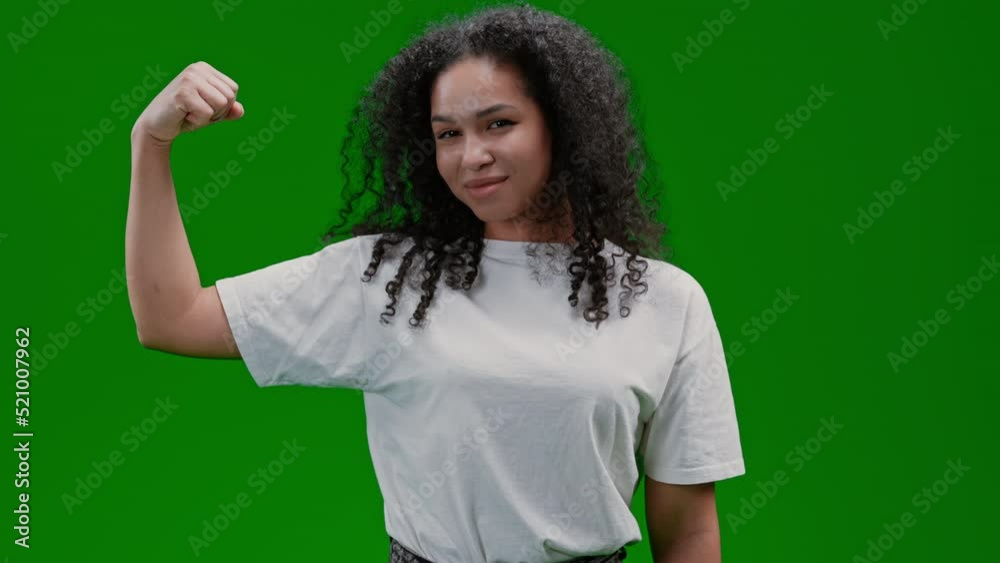 active woman in a good fit with curly long hair showing biceps on the hand sport and health concept Isolated on Green Screen active woman in a good fit with curly long hair showing biceps on the hand sport and health concept Isolated on Green Screen
